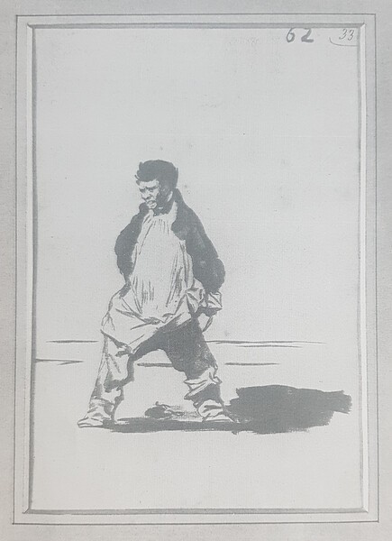 Villager in the field rolling up his trousers